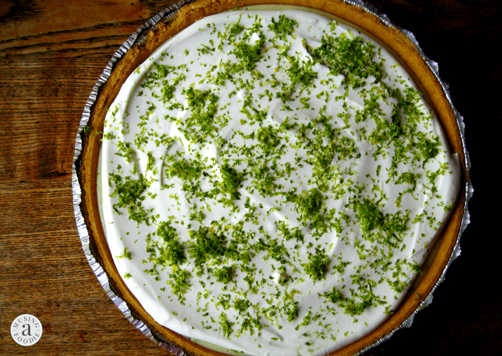 Homemade key lime pie in a graham cracker crust with fresh lime zest.
