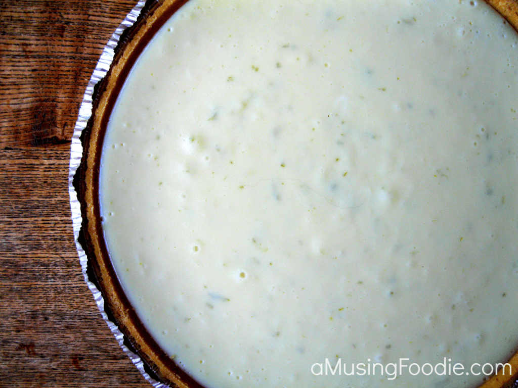 Homemade Key Lime Pie Recipe Homemade key lime pie cooling in a graham cracker crust, just before the sour cream topping and fresh lime zest is added.