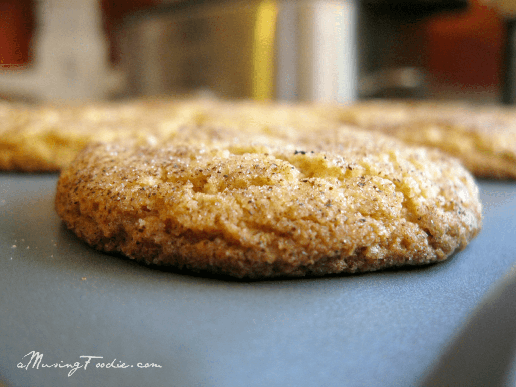 Snickerdoodle Close up side shot of a freshly baked Snickerdoodle cookie on a baking sheet.