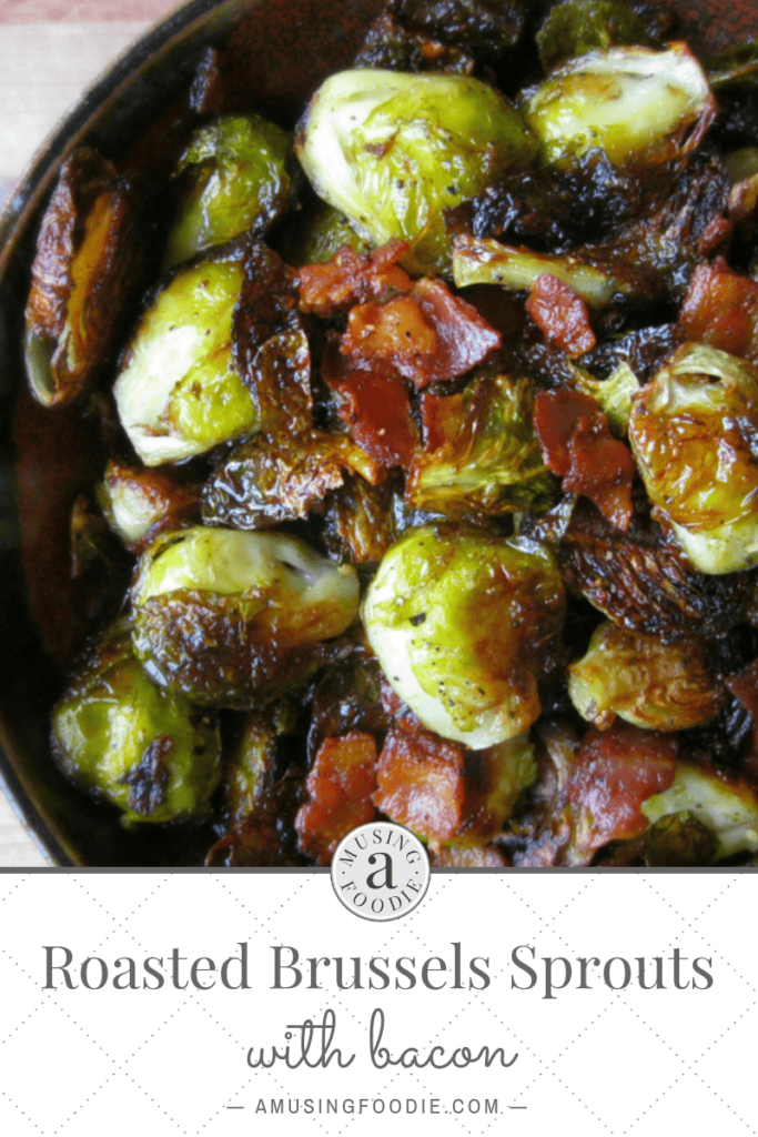 Close up of roasted brussels sprouts with bacon in a brown ceramic bowl.