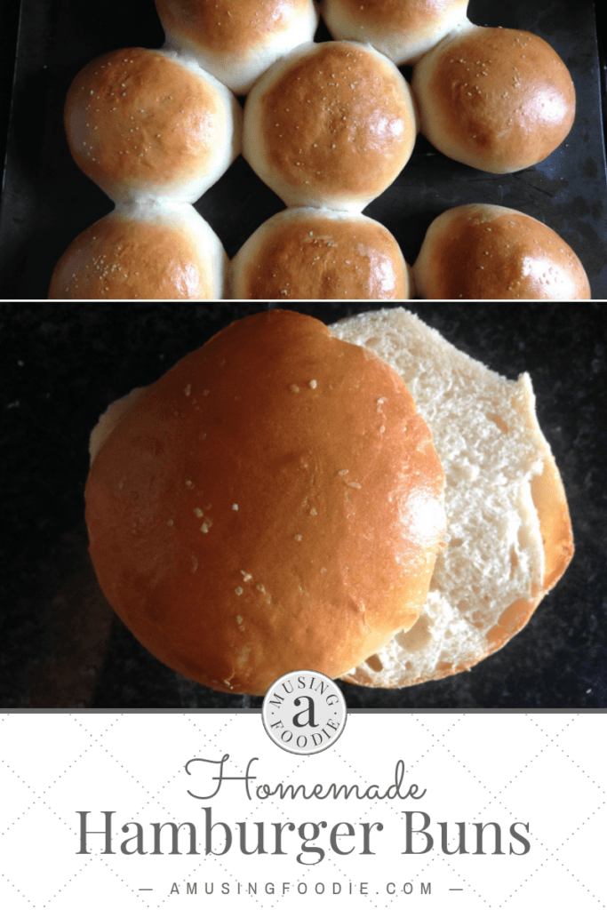 Homemade hamburger buns on a dark counter.