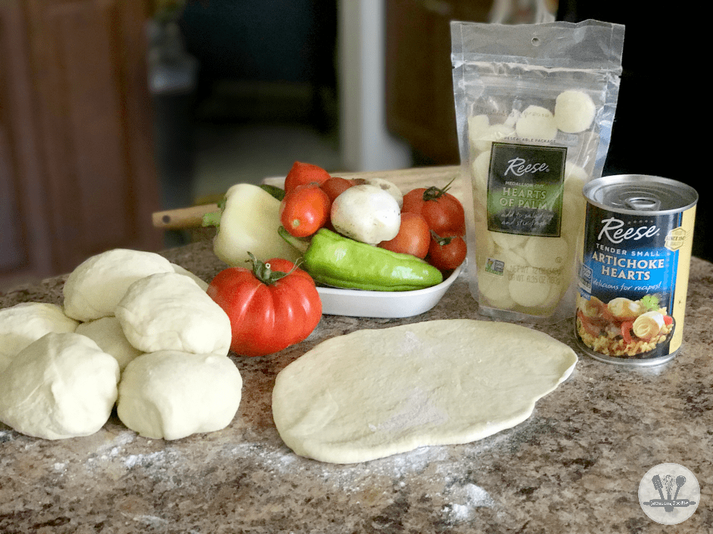 This rustic homemade pizza, loaded with yummy veggies like hearts of palm, sweet peppers, tender small artichoke hearts, fresh tomatoes, is the perfect dinner for summer!