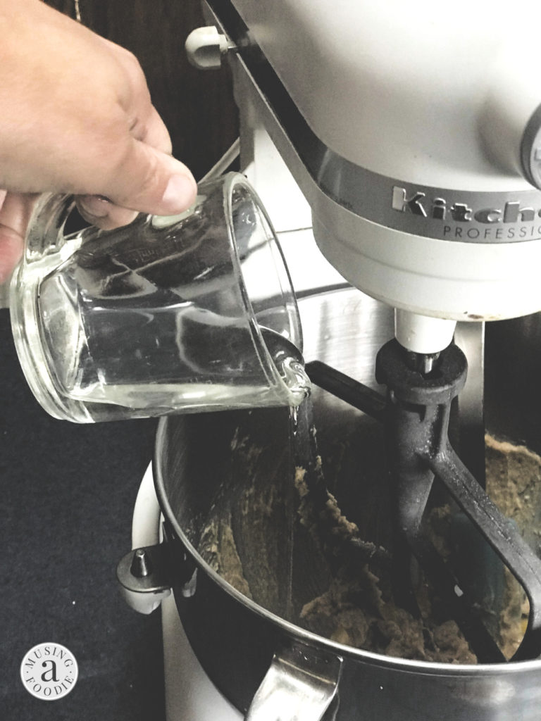 Karo® Corn Syrup being poured into the bowl of a stand mixer.