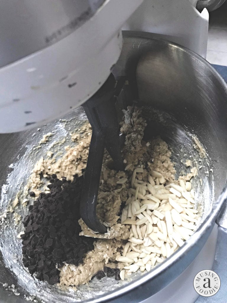 Chocolate chips and slivered almonds added to cookie batter before mixing.