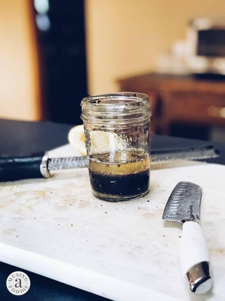 Mazola Corn Oil in a small mason jar with balsamic vinegar and lemon juice.