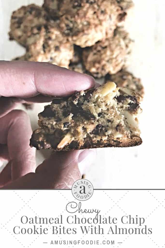 Inside of a chewy oatmeal chocolate chip cookie with almonds.