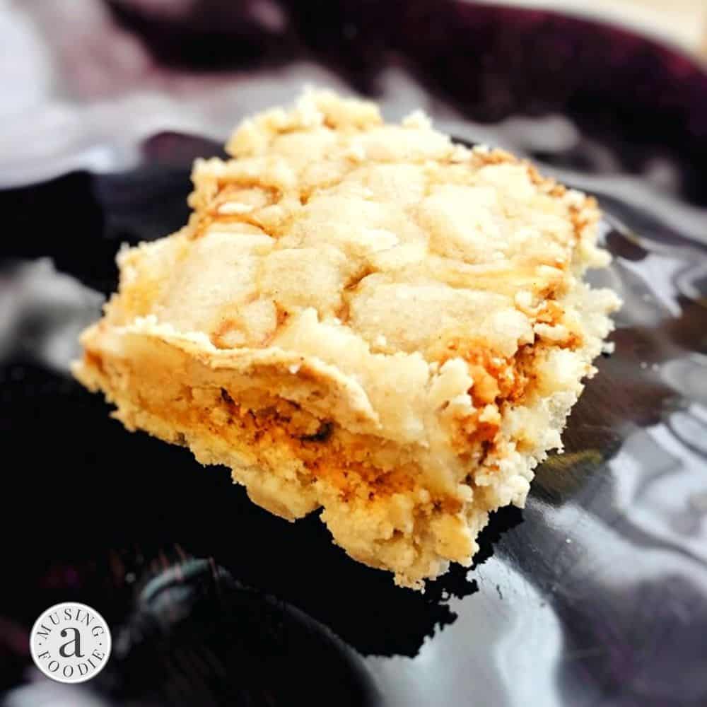 Gluten free pumpkin cheesecake bar on a plate.